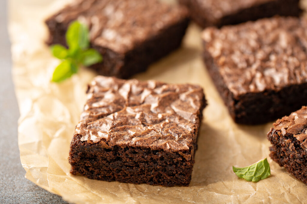Some complete normal delicious brownies with some completely normal mint leaves.